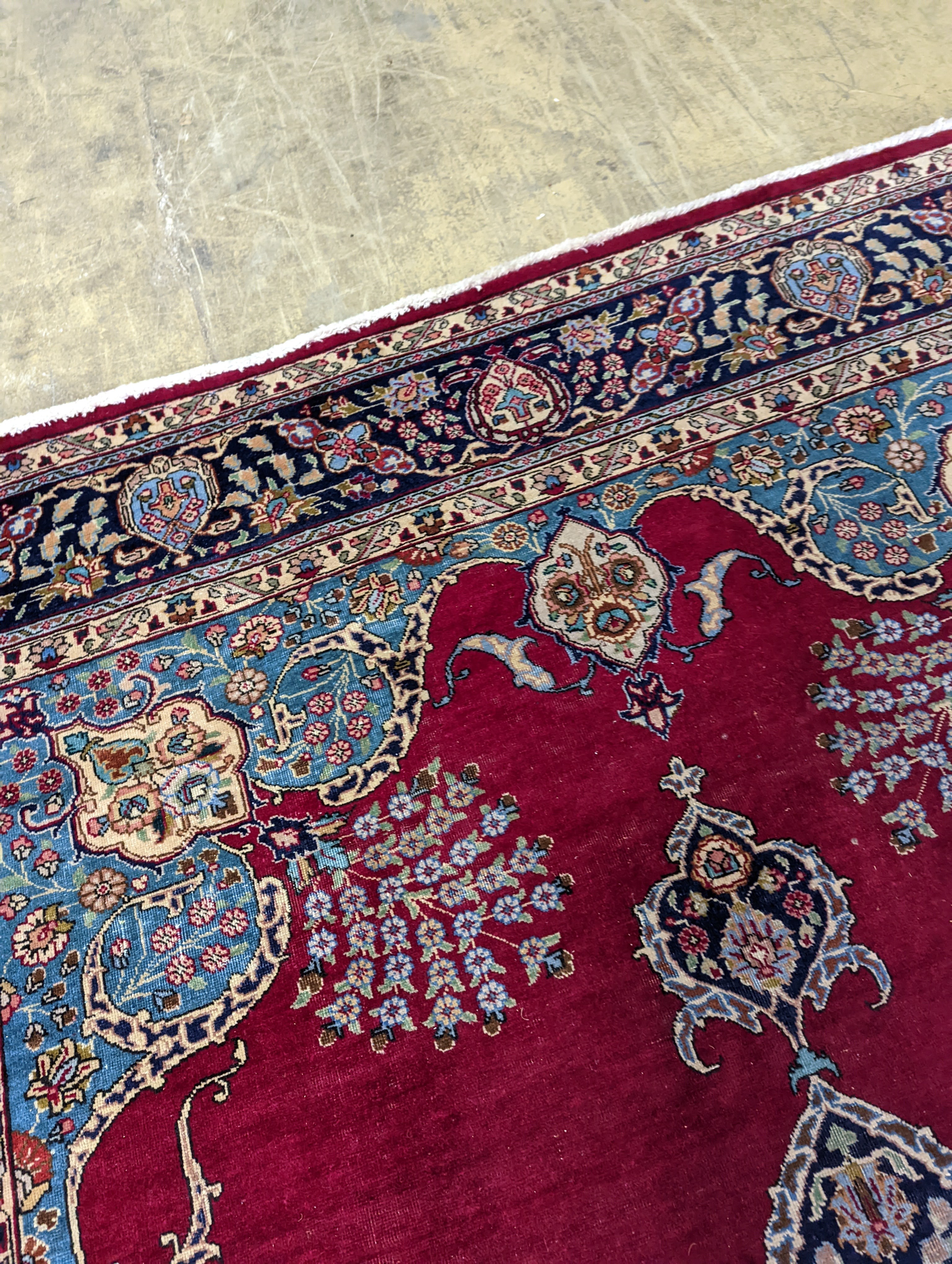 A Tabriz burgundy ground carpet, 350 x 240cm